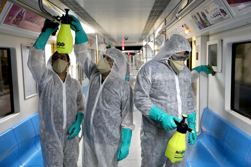 Workers disinfect subway trains against coronavirus in Tehran, Iran, in the early morning AP
