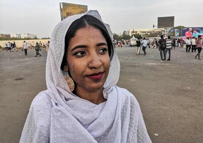 Alaa Salah, a Sudanese woman propelled to internet fame earlier this week after clips went viral of her leading powerful protest chants against President Omar al-Bashir, attends a demonstration in front of the military headquarters in the capital Khartoum on April 10, 2019. In the clips and photos, the elegant Salah stands atop a car wearing a long white headscarf and skirt as she sings and works the crowd, her golden full-moon earings reflecting light from the fading sunset and a sea of camera phones surrounding her. Dubbed online as "Kandaka", or Nubian queen, she has become a symbol of the protests which she says have traditionally had a female backbone in Sudan.
 / AFP / -
