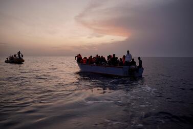 Migrants on an overcrowded wooden boat wait to be rescued in the Mediterranean Sea earlier this month. AP