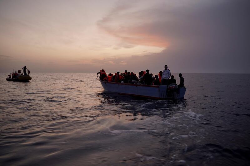 Migrants on an overcrowded wooden boat wait to be rescued in the Mediterranean Sea, Thursday, Sept. 19, 2019. The Ocean Viking, jointly operated by SOS Mediterranee and Doctors Without Borders, rescued 36 people from the small wooden boat after being requested to do so by Maltese authorities. (AP Photo/Renata Brito)