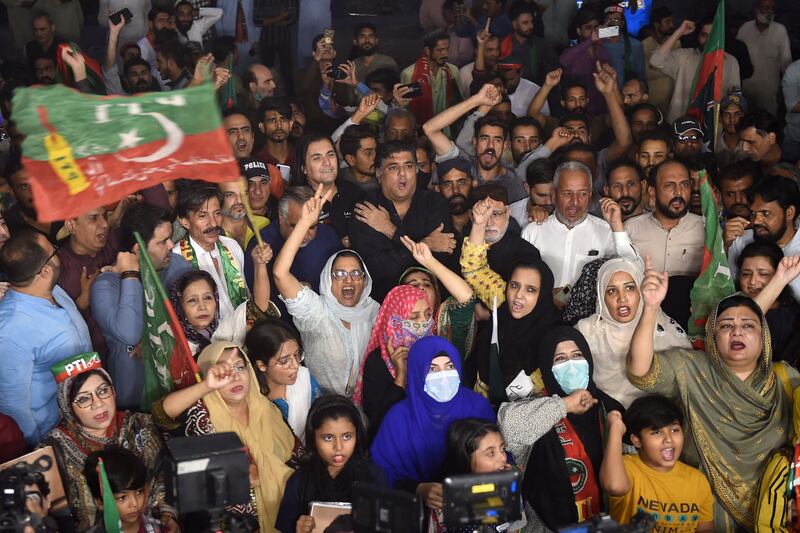 Supporters of Mr Khan shout slogans during a protest against last weeks' assassination on him. AFP