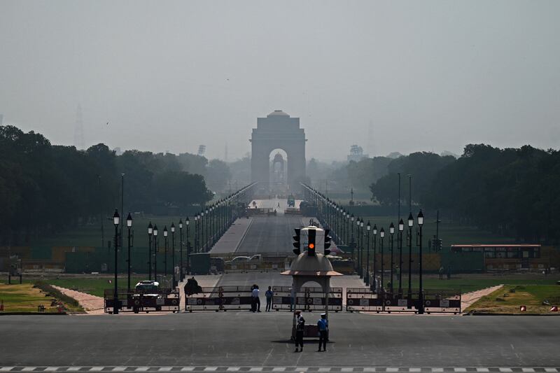 Military police stand guard against the backdrop of India Gate on a hot summer day in New Delhi. AFP