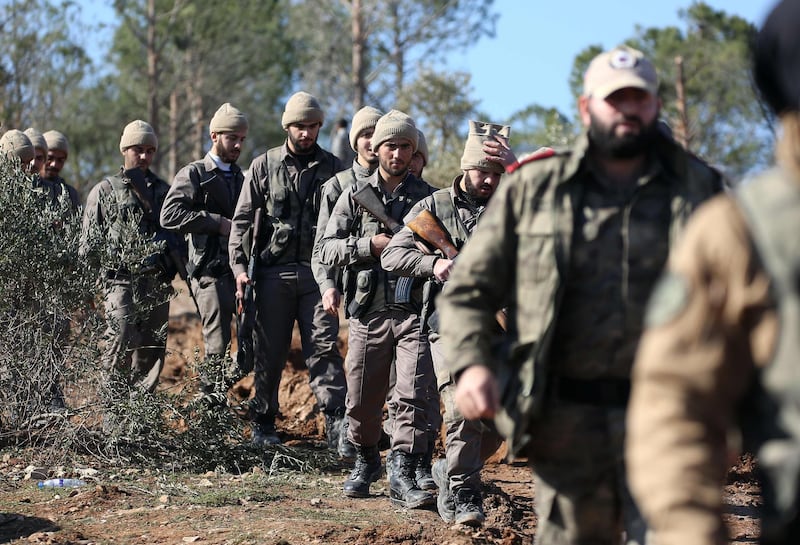 Turkish-backed Syrian rebels march on Mount Barsaya north of Azaz, on January 29, 2018, as the Turkish offensive against Kurdish forces in the Syrian border region of Afrin continues.
Turkey launched operation "Olive Branch" on January 20 against the Syrian Kurdish People's Protection Units (YPG) militia in Afrin, supporting Syrian opposition fighters with ground troops and air strikes. / AFP PHOTO / Nazeer al-Khatib