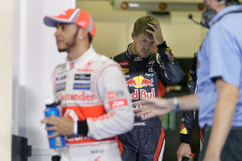 Abu Dhabi, United Arab Emirates, November 3, 2012:    Red Bull Formula One driver Sebastian Vettel, center, of Germany grimices after placing third behind McLaren driver Lewis Hamilton of Great Britain who took pole position during the qualifying session of the Formula 1 Etihad Airways Abu Dhabi Grand Prix at Yas Marina Circuit in Abu Dhabi on November 3, 2012. Christopher Pike / The National






