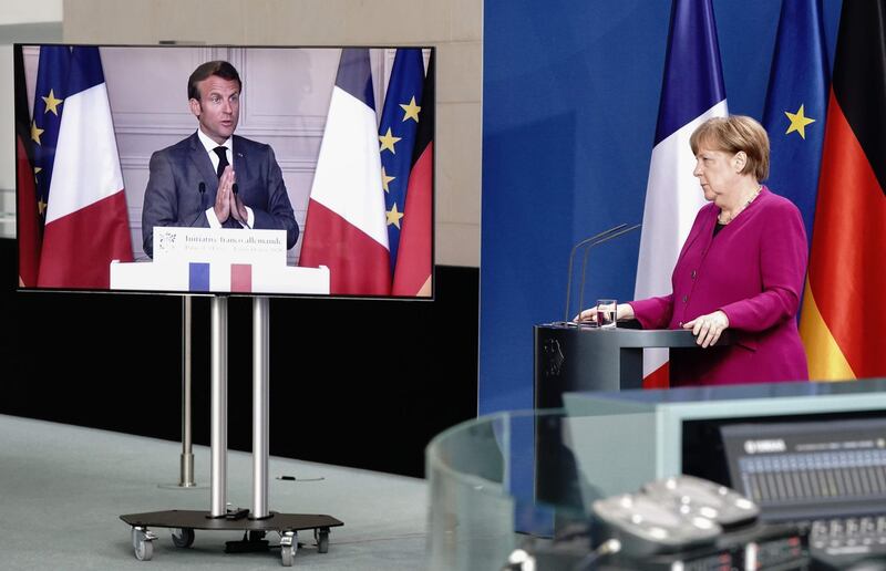 TOPSHOT - German Chancellor Angela Merkel listens during a joint press conference with French President Emmanuel Macron, who attends via video link, at the Chancellery in Berlin, Germany, on May 18, 2020 on the effects of the novel coronavirus COVID-19 pandemic. / AFP / POOL / Kay NIETFELD
