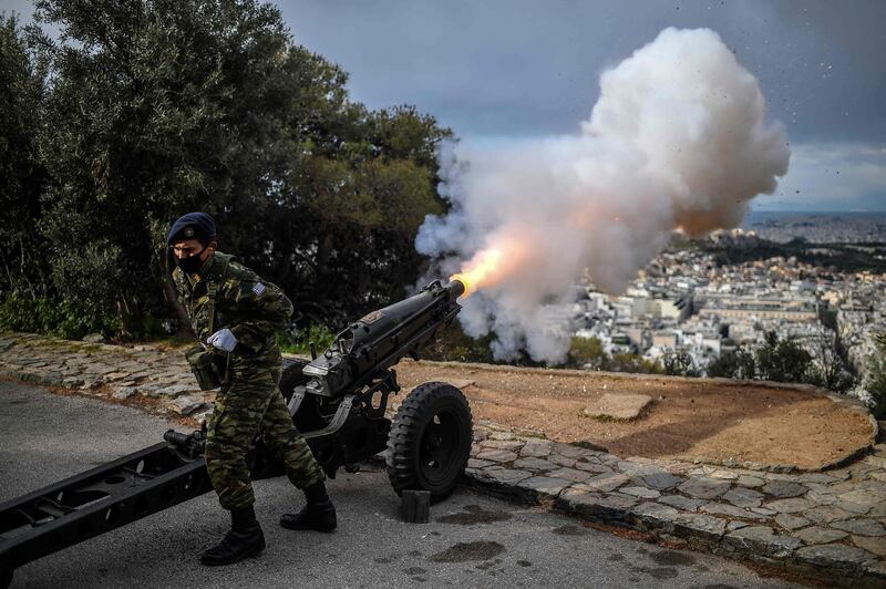 A soldier fires a cannon from Lycabettus hill as Greece celebrates the 200th anniversary of the 1821 Revolution and War of Independence. AFP