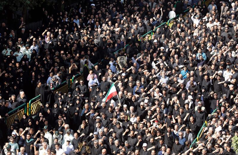 Iranians mourn during a funeral procession for 130 Iranian soldiers killed in the Iran-Iraq war (1980-1988), whose bodies were recently returned from Iraq, in Tehran, Iran.  AFP