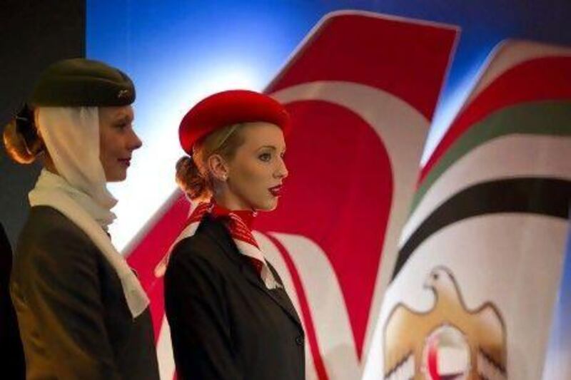 Air hostesses from Etihad Airways, left, and Air Berlin stand on the podium during a press conference in Berlin announcing the share sale. AFP