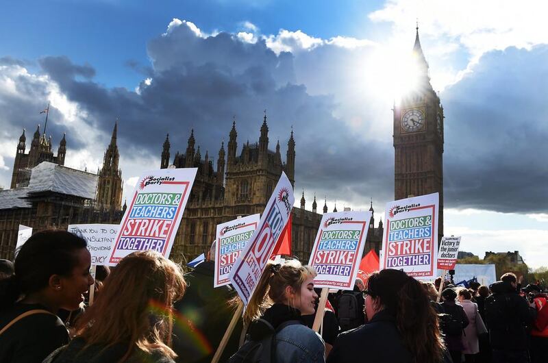 Junior doctors march across Westminster Bridge during a protest in London. Junior doctors are holding a 48-hour strike calling for more pay and better working conditions, as the contract dispute with the government continues to drag on. Andy Rain / EPA