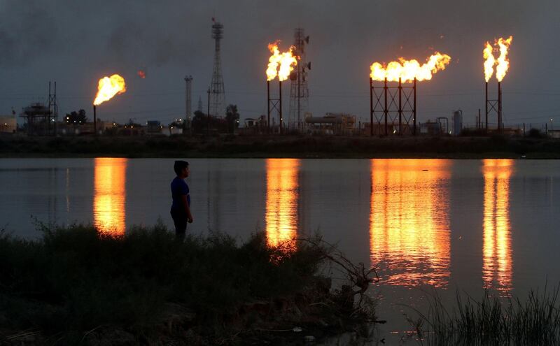 Flames emerge from flare stacks at Nahr Bin Umar oil field, north of Basra, Iraq. Reuters