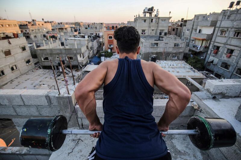 A Palestinian body builder uses construction equipment to train in the southern Gaza Strip city of Rafah  during the lockdown amid the COVID-19 outbreak.   AFP