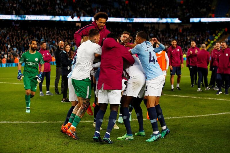 The Manchester City squad hug Yaya Toure during a ceremony after the match. Jason Cairnduff / Reuters