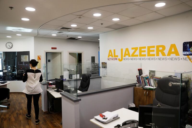 An employee walks inside an office of Qatar-based Al Jazeera network in Jerusalem on June 13, 2017. Reuters / Ronen Zvulun