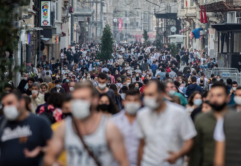 People wearing protective face masks walk in Istiklal Street amid the ongoing coronavirus pandemic in Istanbul, Turkey. According to Turkish Health Ministry reports, Turkey's death toll from coronavirus has risen to 9,584 on 23 October 2020 amid spike in new coronavirus cases in the country.  EPA