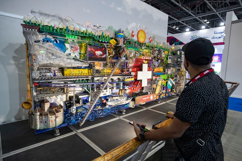 A visitor looks at an artwork at the Swiss Tourism stand at the conference, which is celebrating its 30th year. Chris Whiteoak / The National