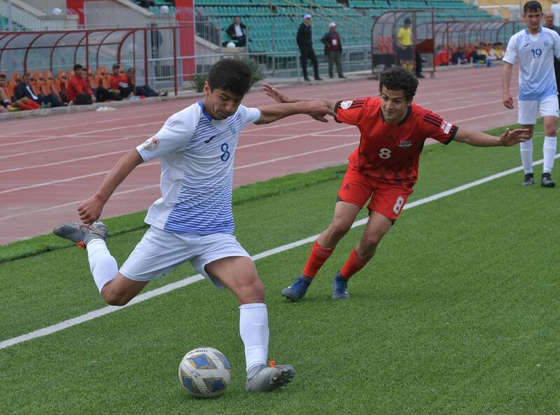 FC Fayzkand's Dzhamshed Murodov in action with FC Lokomotiv-Pamir's Shukhrat Elmurodov. Reuters