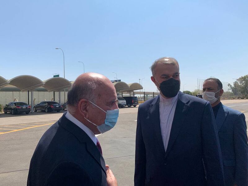 Iraq's Foreign Minister Fuad Hussein, left, welcomes his Iranian counterpart Hossein Amir-Abdollahian at Baghdad airport. AFP