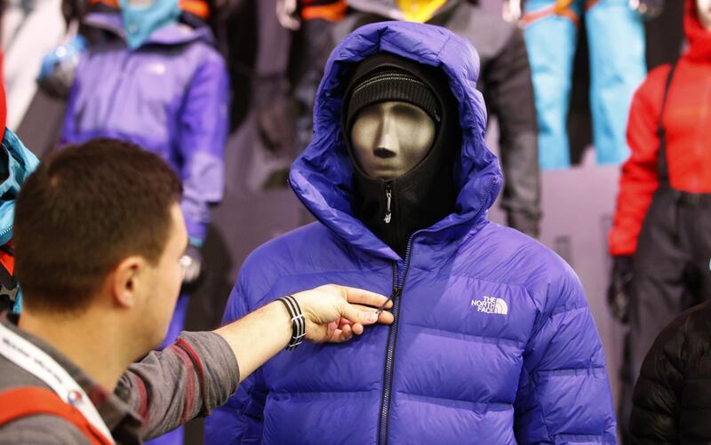 An attendee inspects a North Face Inc. jacket at the company's booth during the 2017 Outdoor Retailers Winter Market Show in Salt Lake City, Utah, U.S., on Wednesday, Jan. 11, 2017. The Bloomberg Consumer Comfort Index, a survey which measures attitudes about the economy, is scheduled to be released on January 12. Photographer: George Frey/Bloomberg