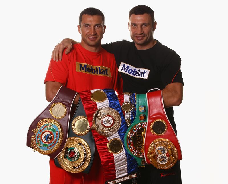 Wladimir Klitschko, left, and his brother Vitali pose with their championship belts in 2012. Getty Images