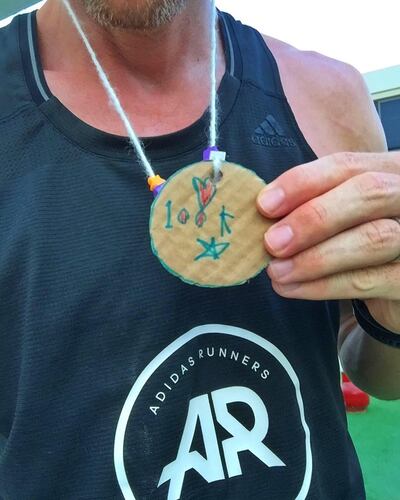 Dubai runner Lee Ryan with a medal made by daughter, Lily. Courtesy Lee Ryan 