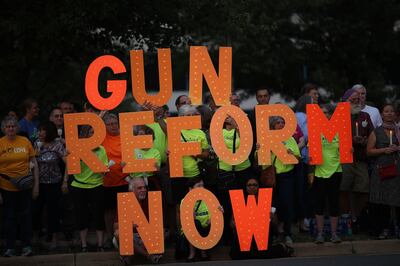 FAIRFAX, VIRGINIA - AUGUST 05: Advocates of gun reform legislation hold a candle light vigil for victims of recent mass shootings outside the headquarters of the National Rifle Association August 5, 2019 in Fairfax, Virginia. Thirty-one people have died following the two mass shootings over the weekend in El Paso, Texas and Dayton, Ohio.   Win McNamee/Getty Images/AFP
== FOR NEWSPAPERS, INTERNET, TELCOS & TELEVISION USE ONLY ==
