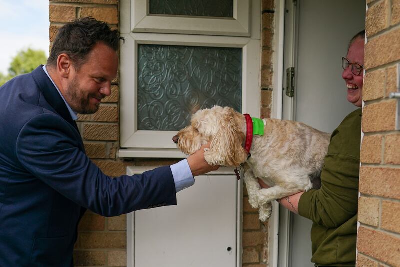 Simon Lightwood, Labour MP for Wakefield, pets a dog as he campaigns on polling day in Selby. Getty