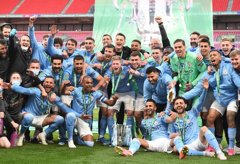 epa09159133 Players of Manchester City celebrate with the trophy after winning the Carabao Cup Final between Manchester City and Tottenham Hotspur at Wembley in London, Britain, 25 April 2021.  EPA/ANDY RAIN EDITORIAL USE ONLY. No use with unauthorized audio, video, data, fixture lists, club/league logos or 'live' services. Online in-match use limited to 120 images, no video emulation. No use in betting, games or single club/league/player publications.