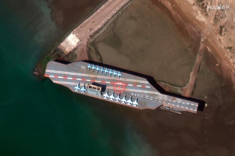 This handout satellite image obtained courtesy of  Maxar Technologies shows an Iran Mockup Aircraft Carrier in Bandar Abbas. AFP