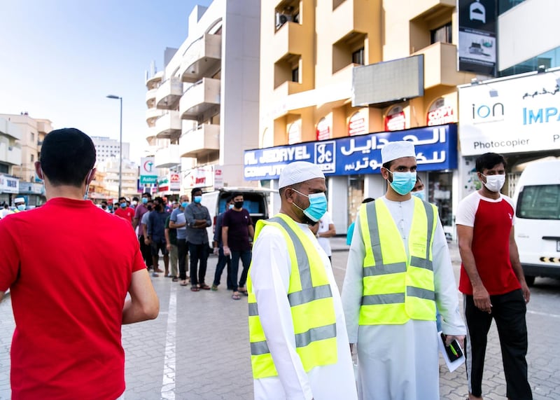 DUBAI, UNITED ARAB EMIRATES. 27 APRIL 2020. 
People line up in Bur Dubai to receive an iftar pack from volunteers of the Kerala NGO Markaz.
(Photo: Reem Mohammed/The National)

Reporter:
Section: