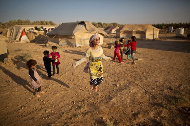 Syrian refugee Zubaida Faisal, 10, skipping rope at an informal tented settlement near the Syrian border on the outskirts of Mafraq, Jordan. AP Photo