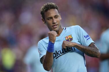 (FILES) In this file photo taken on July 26, 2017 Neymar of Barcelona gestures after scoring during their International Champions Cup (ICC) football match against Manchester United at the FedExField, in Landover, Maryland. Paris Saint-Germain forward Neymar owes more unpaid tax than any other individual on a Spanish authorities' blacklist with debts of 34.6 million euros ($40.5 million), according to an official document published on September 30, 2020. The Brazilian, who played for Barcelona from 2013 to 2017, tops the list of thousands of names that was made public by the Spanish tax office. / AFP / Brendan Smialowski