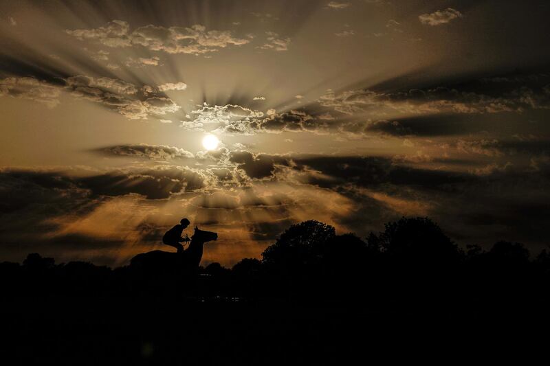 A runner makes its way to the start as the evening sun begins to set at Windsor Racecourse in the United Kingdom. Alan Crowhurst/Getty Images
