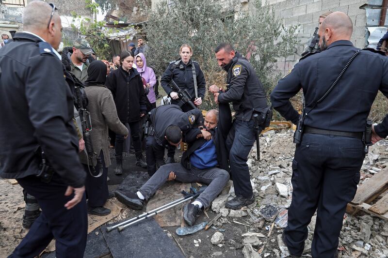 Israeli police officers detain a Palestinian during a protest supporting Palestinian families who are under threat of eviction from their longtime homes by Jewish settlers in the east Jerusalem neighbourhood of Sheikh Jarrah last December. AP Photo