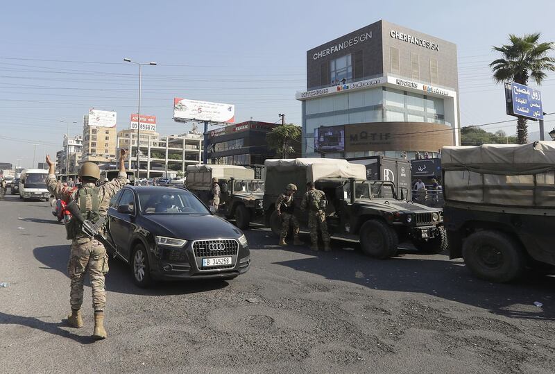 A Lebanese army soldier directs traffic after opening the Tripoli-Beirut highway, blocked earlier amid ongoing anti-government demonstrations, in Zouk Mosbeh, north of the capital Beirut, on November 5, 2019. Nationwide cross-sectarian rallies have gripped Lebanon since October 17, demanding a complete overhaul of a political system deemed inefficient and corrupt. The movement forced the government to resign last week and has spurred a raft of promises from political leaders, who have vowed to enact serious reforms to combat corruption. / AFP / JOSEPH EID
