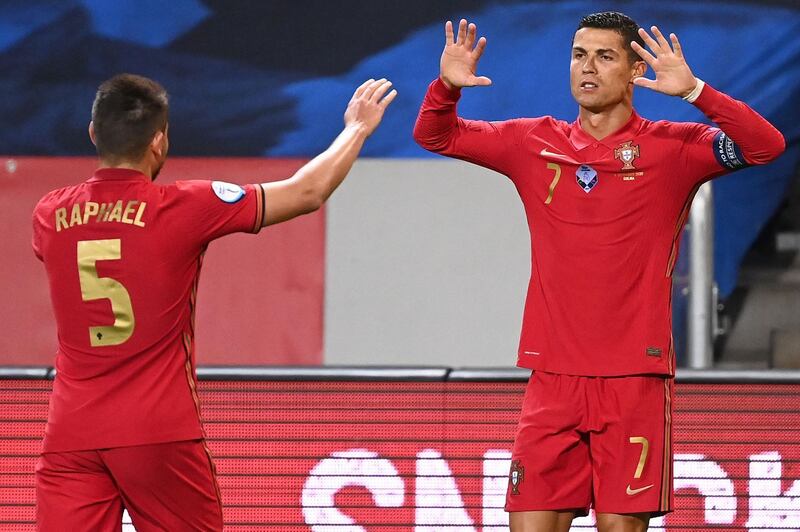 Cristiano Ronaldo celebrates scoring his second goal with Raphael Guerreiro. AFP