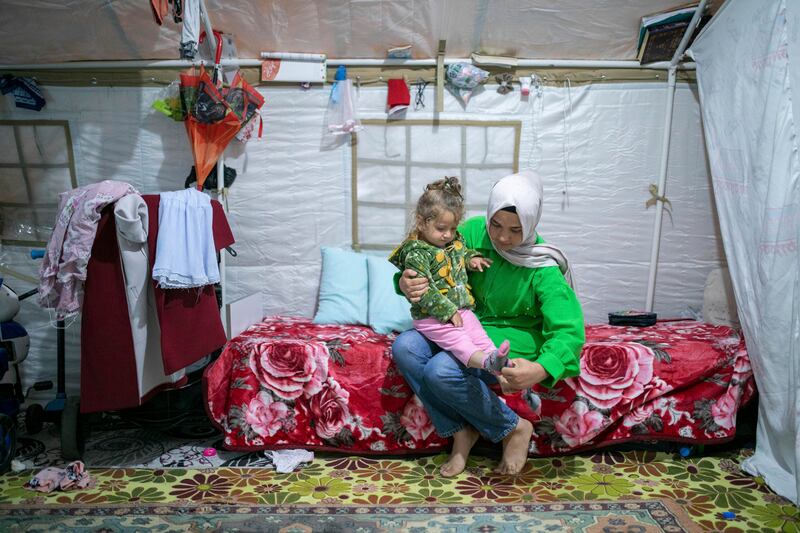 Earthquake survivors Kubra Goknar and her daughter Leyla in their tent in Kahramanmaras, south-eastern Turkey. AP