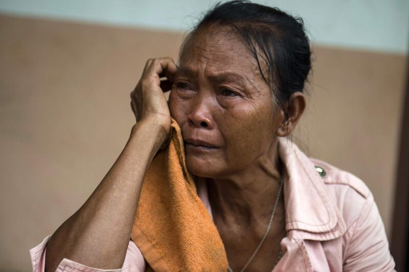 An elderly flood victim cries as she takes shelter in a school compound in Sanamxai, Attapeu province. AFP