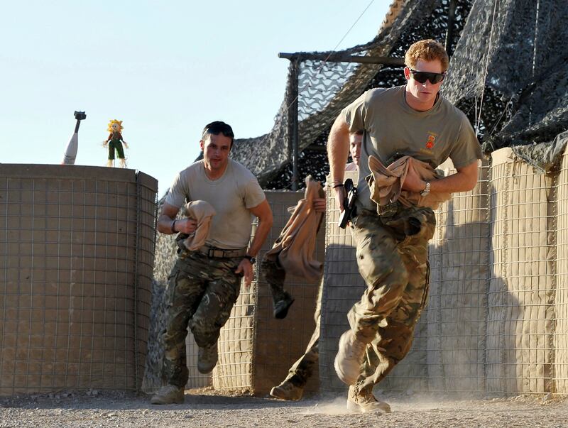 Prince Harry and fellow pilots race from their tents to scramble their Apaches. AP