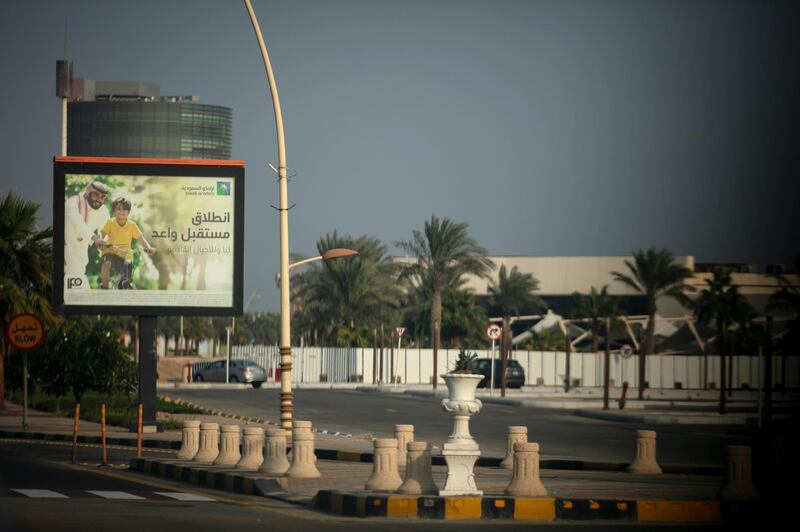 An advertisment for the Saudi Aramco IPO stands beside a highway in Eastern Province near Dhahran, Saudi Arabia. Bloomberg