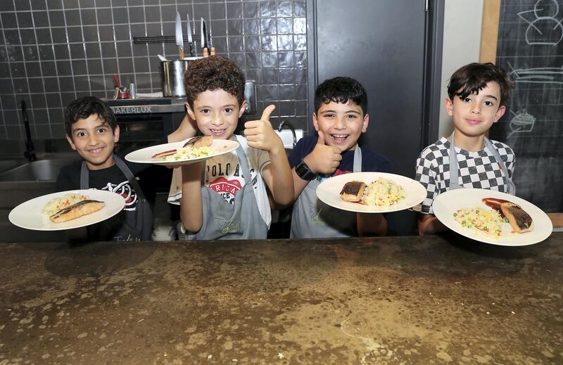 DUBAI, UNITED ARAB EMIRATES , March 5  – 2020 :- Left to Right- Radwan, Yaseen, Yazan and Ismaiel with the dishes after the cooking class  at the Top Chef Dubai cooking school on Jumeirah Beach Road in Dubai. (Pawan Singh / The National) For Lifestyle. Story by Janice Rodrigues