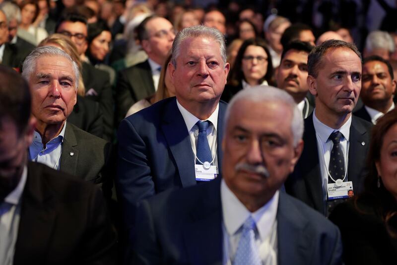 Former US Vice President Al Gore sits in the audience and listens as US President Donald Trump delivers the opening remarks at the World Economic Forum in Davos. AP Photo