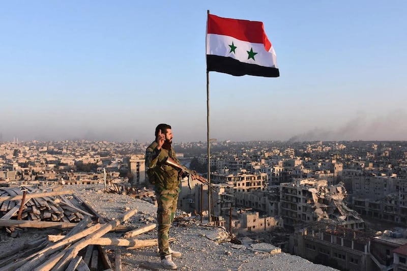 A Syrian pro-government fighter stands on top of a building overlooking Aleppo in the city's eastern Bustan Al Basha neighbourhood on November 28, 2016. George Ourfalian/AFP  



