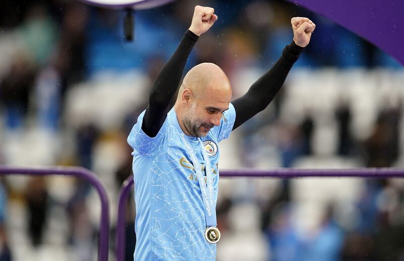Manchester City manager Pep Guardiola celebrates with the Premier League medal at the Etihad Stadium. PA