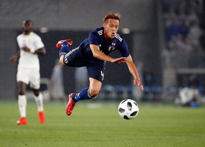 epa06773229 Japan's midfielder Keisuke Honda falls after colliding with Ghana's defender Andrew Kyere-Yiadom (not pictured) during a friendly soccer match between Japan and Ghana in Yokohama, near Tokyo, Japan, 30 May 2018.  EPA/FRANCK ROBICHON