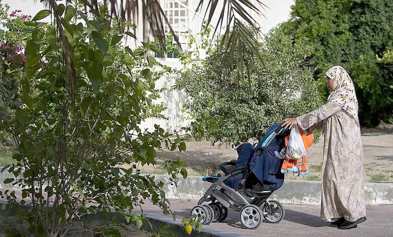 United Arab Emirates -Dubai- May 15, 2009:

HOUSE & HOME: A nanny takes a child out for a stroll in the Nad Al Sheba neighborhood in Dubai on Friday, May 15, 2009. Amy Leang/The National
 *** Local Caption ***  amy_051509_nadalsheba_21.jpgamy_051509_nadalsheba_21.jpg