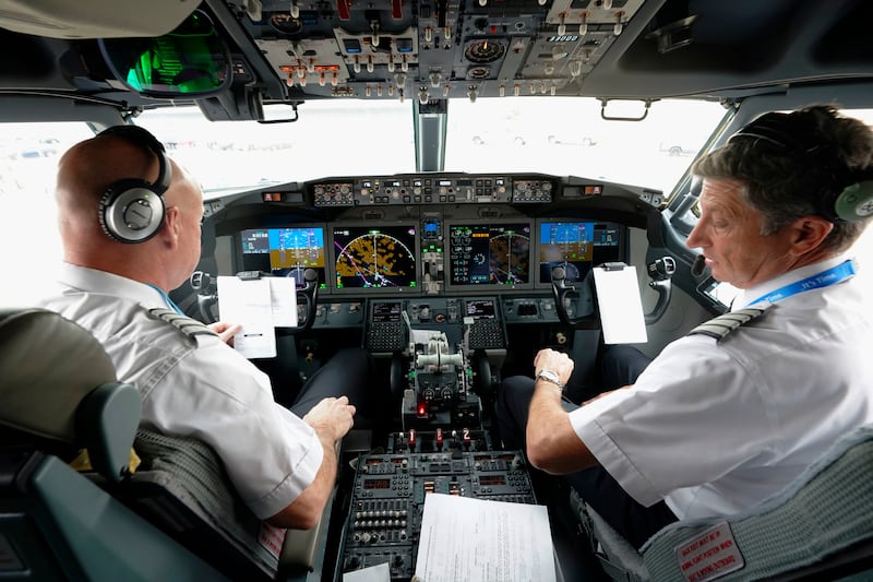 American Airlines pilots conduct a pre-flight check in the cockpit of a Boeing 737 Max jet before leaving Dallas. AP