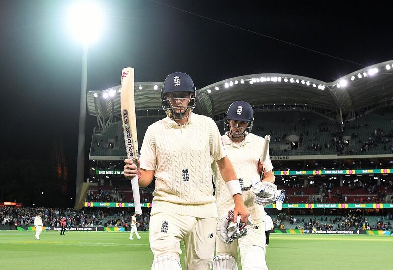 Joe Root, left, and Chris Woakes leave the field at stumps on Day 4. Dave Hunt / EPA