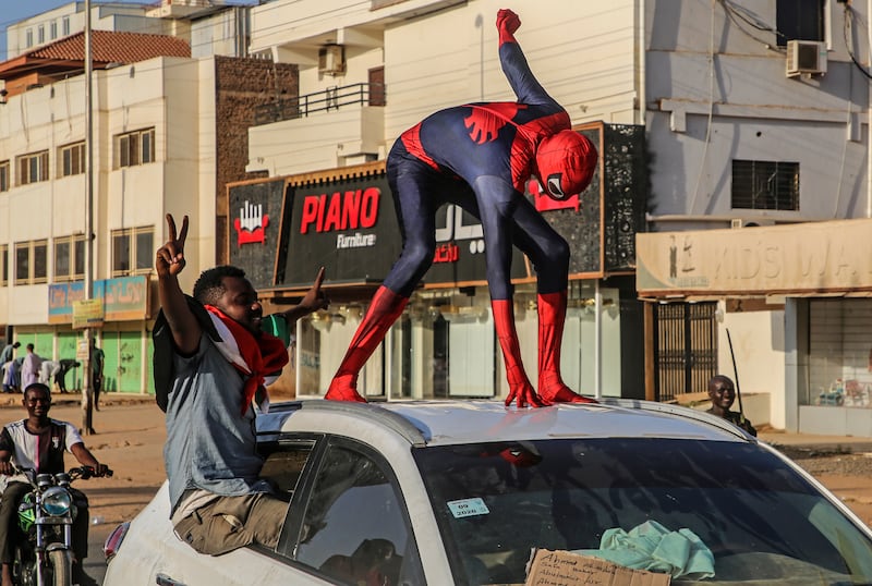 A Sudanese protester dressed up as Spider-Man, stands on car during an anti-coup protest in the capital Khartoum.  EPA