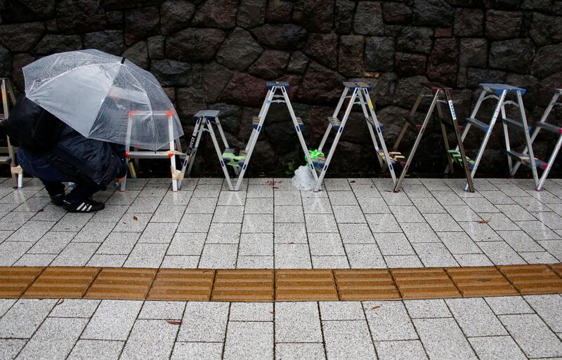 Stepladders used for election coverage by photographers are lined up outside of the ruling Liberal Democratic Party headquarters as Typhoon Lan approaches Japan's mainland in Tokyo. Issei Kato / Reuters