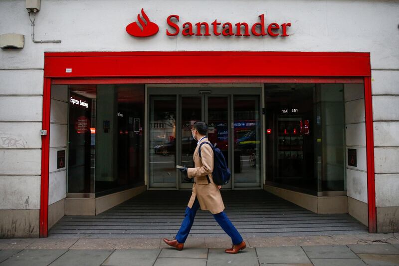 A pedestrian, wearing a protective face mask, passes a Satander bank branch, operated by Banco Santander SA, in London, U.K., on Thursday, March 19, 2020. U.K. Prime Minister Boris Johnson's government is considering tougher action to fight the spread of the coronavirus in London but has denied it is planning to confine residents to their homes or seal off the city. Photographer: Hollie Adams/Bloomberg